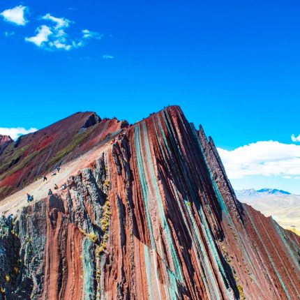 Pallay Punchu mountain in Cusco, Peru, with its distinct colorful stripes and sharp, pointed peaks.
