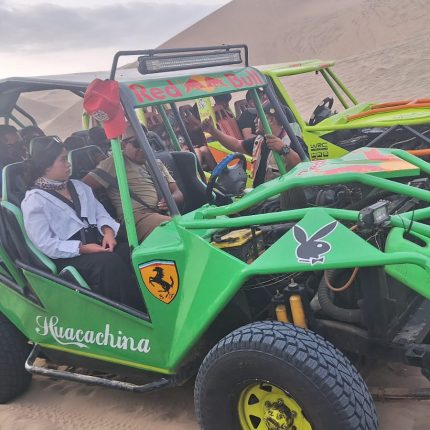 Dune buggy driving up a massive sand dune in the Huacachina Oasis, Ica, during the Ica & Paracas full-day tour.