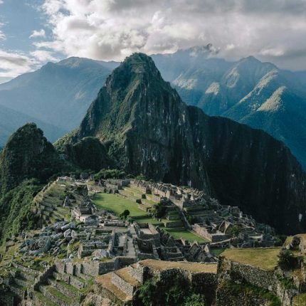 Huayna Picchu mountain and ancient stone ruins at Machu Picchu citadel after completing the Lares Trek.
